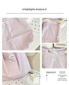 Detailed close-up of purple striped canvas tote bag fabric and woven label brand design