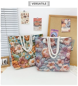 Detail of floral embroidered canvas tote bags with rope handles in vibrant colors