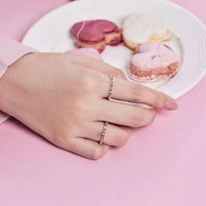 Detailed close-up of a silver ring with pink, purple and orange cubic zirconia stones