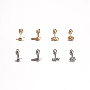 Detail of lightning and geometric stainless steel stud earrings in gold and silver