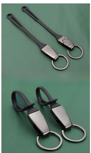 Macro detail of flexible black silicone strap with gunmetal gray buckle for car keychain