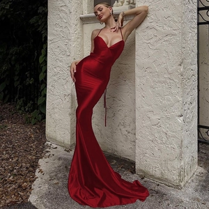 Detail of red backless halter neck satin dress with elegant fishtail hemline