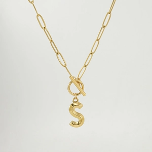 Detail of 18K gold paperclip chain necklace with OT buckle and letter S pendant