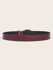 Detail view of burgundy faux leather belt featuring crocodile texture and metal buckle