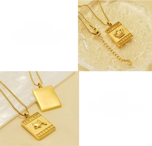 Detail of square titanium steel necklace with crown relief and brushed metal back finish