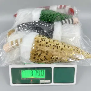 Logistics photo showing a package of sequined Christmas gnomes weighing 379 grams on a scale