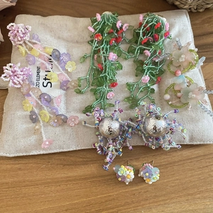 Pendientes de cuentas florales y con flecos vibrantes en bolsa de lino rústica