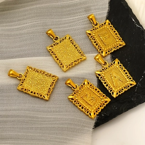 Five gold-plated stainless steel rectangular alphabet pendants on satin and rock textures