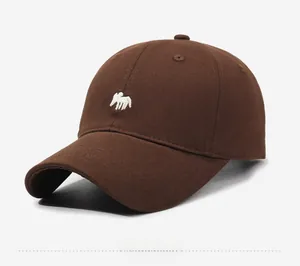 Detail view of the small white elk embroidery on the side of a dark brown cotton baseball cap