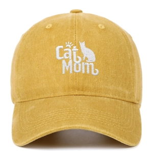 Close-up of Cat Mom embroidery and cat silhouette on washed yellow cotton baseball cap