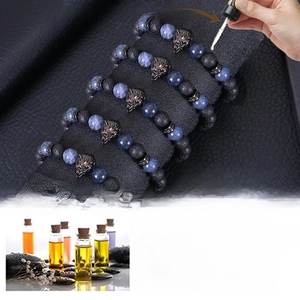 Detail of 8mm blue tiger eye and lava stone wolf bracelet with essential oil diffuser