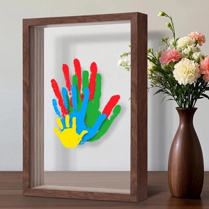 3D walnut wood shadow box frame with colorful family handprints and double-sided glass