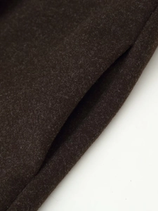 Detailed close-up showing the dark brown wool blend fabric texture and side pocket stitching
