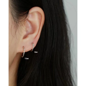 Close-up showing 8mm and 10mm silver S925 sterling silver hoop earrings worn together