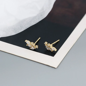 Macro shot of gold-plated flower cluster earrings with sparkling clear cubic zirconia
