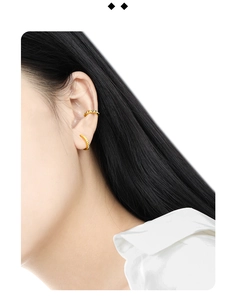 Macro detail of gold S925 sterling silver hoop earrings with geometric vertical textures