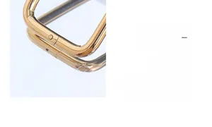 Macro shot of polished 18k gold plated stainless steel buckle with mirror finish