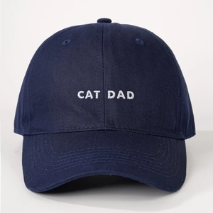 Detailed embroidery of white CAT DAD text on navy blue cotton twill baseball cap