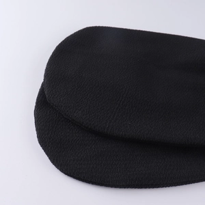 Macro shot of black exfoliating bath mitt with deep cleaning textured fabric weave