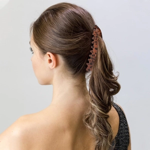 Rear view of a model wearing a 13cm brown leopard print banana hair clip for ponytail styling