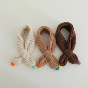 Detailed knit texture of children's winter scarves in cream, camel and dark coffee