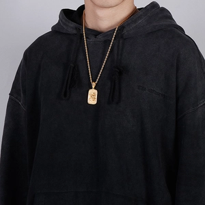 Male model wearing golden rectangular stainless steel pendant with rope chain necklace