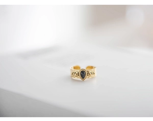 Detail of 18K gold-plated hammered ring with teardrop black gemstone and side gold beads