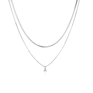 Close-up of double layer silver snake chain necklace with sparkling zircon letter A pendant