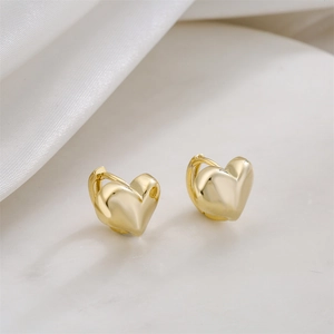 Minimalist 14K gold plated heart hoop earrings on elegant white silk background