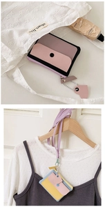 Close-up of macaron color block PU leather coin purses with heart pendants and long lanyards