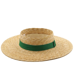 Fashionable straw sun visor hat with wide brim and dark green ribbon for beach travel