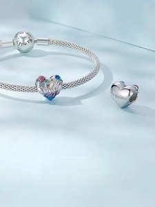 Macro shot of S925 silver swan heart beads and snake chain with Te quiero engraving