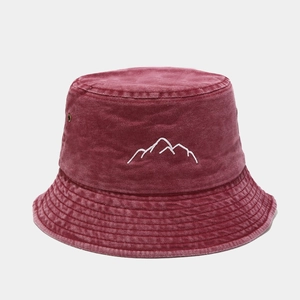 Detail of burgundy washed cotton bucket hat with white mountain peak embroidery and metal eyelets