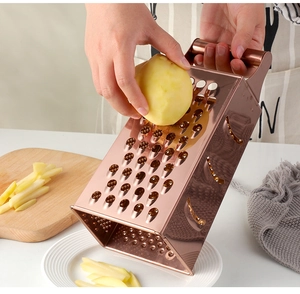 Action shot of rose gold stainless steel 4-sided grater slicing potato in the kitchen