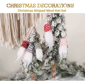 Close-up of knit Christmas gnome ornaments with white fur beards on a snowy Xmas tree