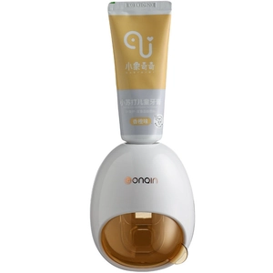 Automatic white wall-mounted toothpaste dispenser with amber window and orange kids toothpaste