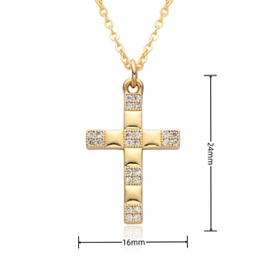 Macro detail of gold cross pendant showing dimensions of 24mm height and 16mm width