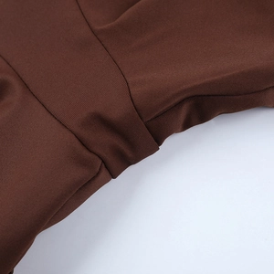 Macro shot of dark brown ribbed knit fabric texture and high-quality stitching details