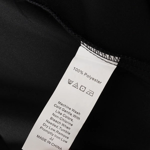 Macro shot of the 100% polyester clothing care label with clear washing instructions