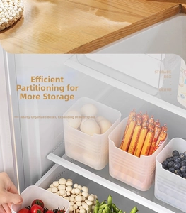 Translucent fridge organizer bins sorting various food items in a refrigerator door