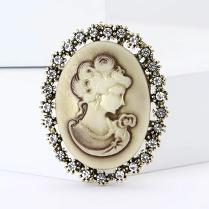 Vintage oval cameo brooch with rhinestone crystal border and female portrait profile
