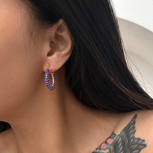 Chic gold hoop earrings for women featuring sparkling blue zircon stones on a model