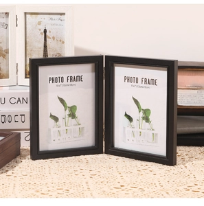 Detail of black wood folding 5x7 photo frame with metal hinges and high-quality glass cover