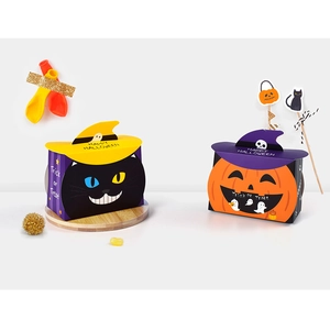 Detail view of pumpkin and black cat Halloween candy gift boxes with wizard hat lids