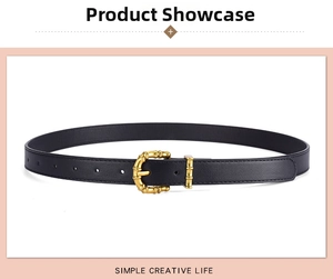 Detail of black PU leather belt featuring a golden bamboo style metal pin buckle