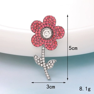 Detailed view of pink rhinestone flower accessory with dimensions 5cm height and 3cm width