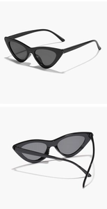 Close-up of black oversized cat eye sunglasses with dark lenses from multiple angles