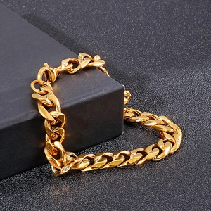 Men's fashion polished gold stainless steel Cuban link chain necklace displayed on a pedestal