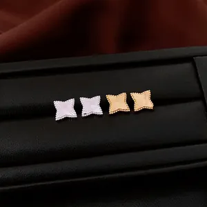 Minimalist textured star earrings in gold and silver finish with radial engraving