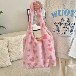 Detailed texture of pink plush tote bag featuring soft faux fur and heart patterns
